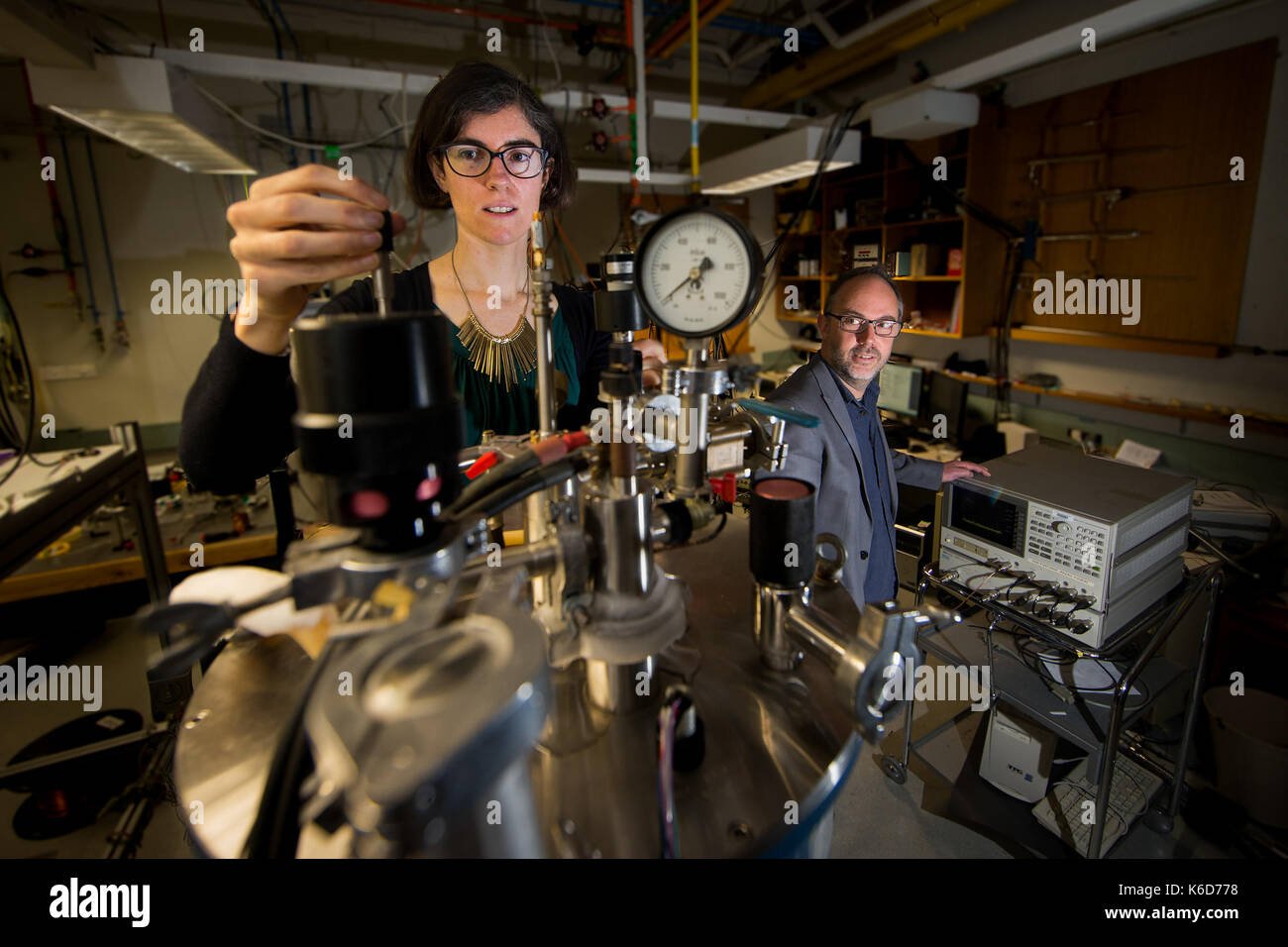 Canberra, Canberra. 6th Sep, 2017. Doctor Rose Ahlefeldt (L) and Associate Professor Matthew Sellars operate a superconducting magnet cryostat, which is used in the experiment to generate a high magnetic field and extremely low temperatures in the Australian National University (ANU), Canberra, on Sept. 6, 2017. Australian scientists have made a significant breakthrough in developing an 'unhackable' quantum internet, it was announced on Sept. 12. Credit: ANU/Stuart Hay/Xinhua/Alamy Live News Stock Photo