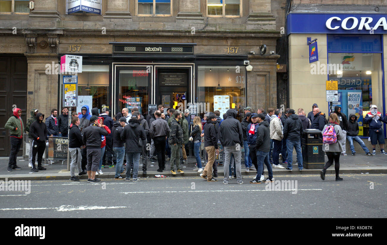 Glasgow, Scotland, UK. 12th Sep, 2017. Paris Saint-Germain Football Club, commonly known as PSG play Glasgow Celtic in the Champions league tonight. PSG ultra fans remain under close scrutiny from police Scotland as they tahe over the sidewalk near a pub on George square . Credit: gerard ferry/Alamy Live News Stock Photo
