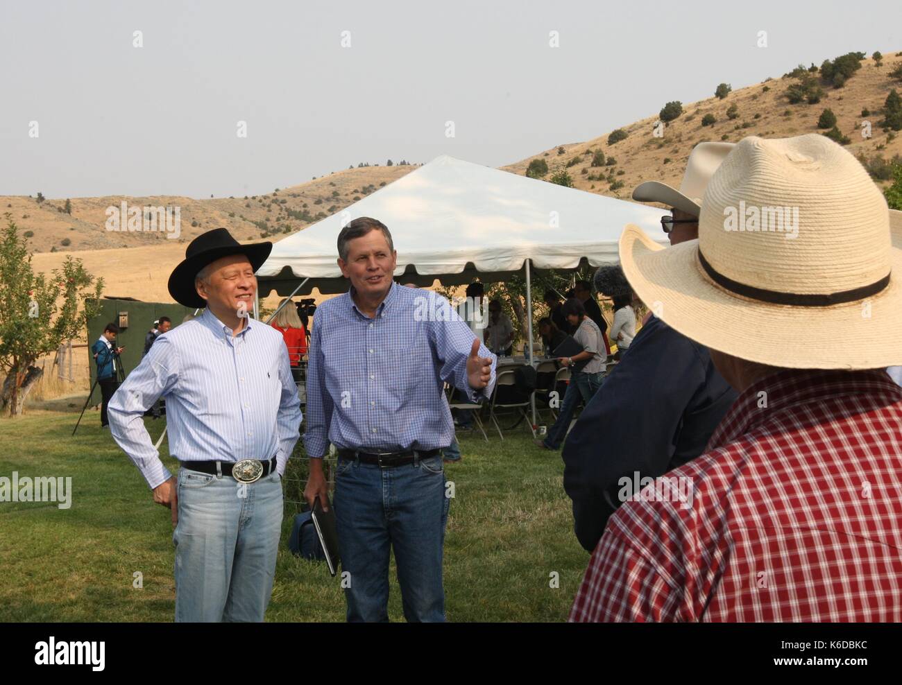 (170912) -- BOZEMAN (U.S.), Sept. 12 (Xinhua) -- Steve Daines (2nd L), a senator from U.S. state of Montana, and Cui Tiankai (1st L), Chinese Ambassador to the United State, speaks with Fred Wacker and other cattle ranchers at the Morgan Ranch House, near downtown Bozeman, Montana, the United States, on Sept. 8, 2017. 'We're very excited that China removed a ban on U.S. beef imports,' said Fred Wacker, a third-generation rancher of Miles City in the northwestern U.S. state of Montana, where there're about three heads of cattle for every person. Two months ago, as part of the 100-day action pla Stock Photo