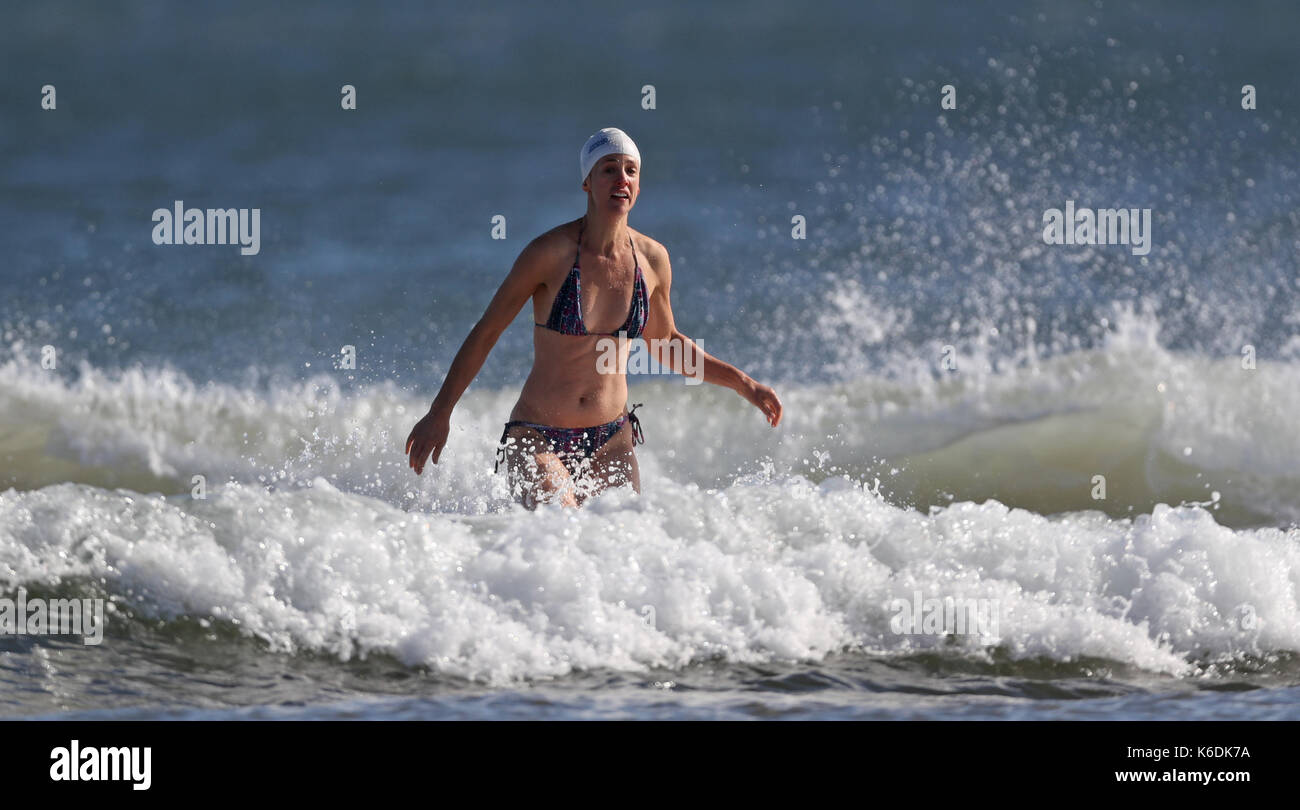 A swimmer on Tynemouth Beach in North Tyneside as the first named storm of the year, Storm Aileen, is set to bring winds of up 75 miles per hour to parts of the UK this week, the Met Office said. Stock Photo