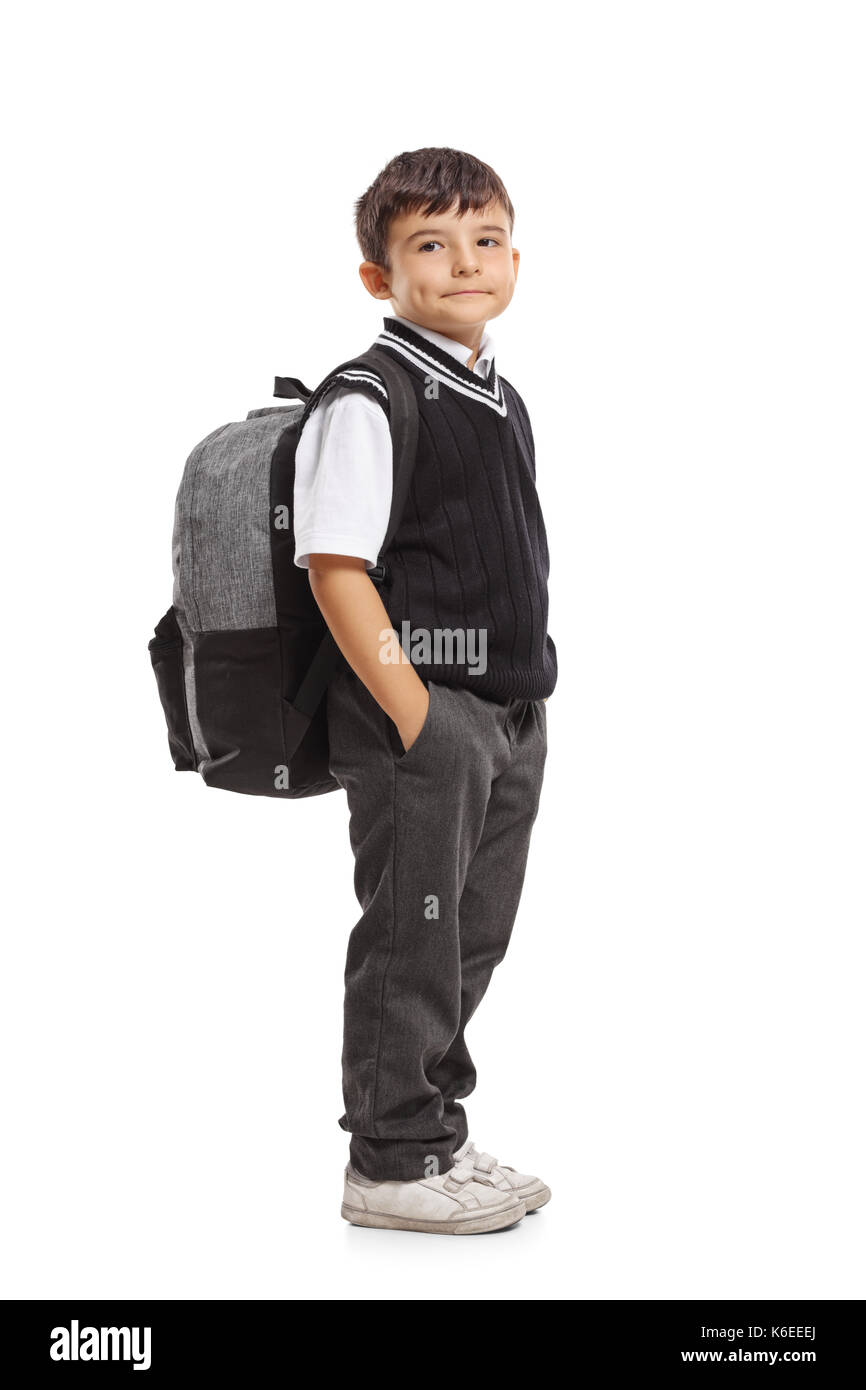 Full length portrait of a small schoolboy with a backpack looking at ...