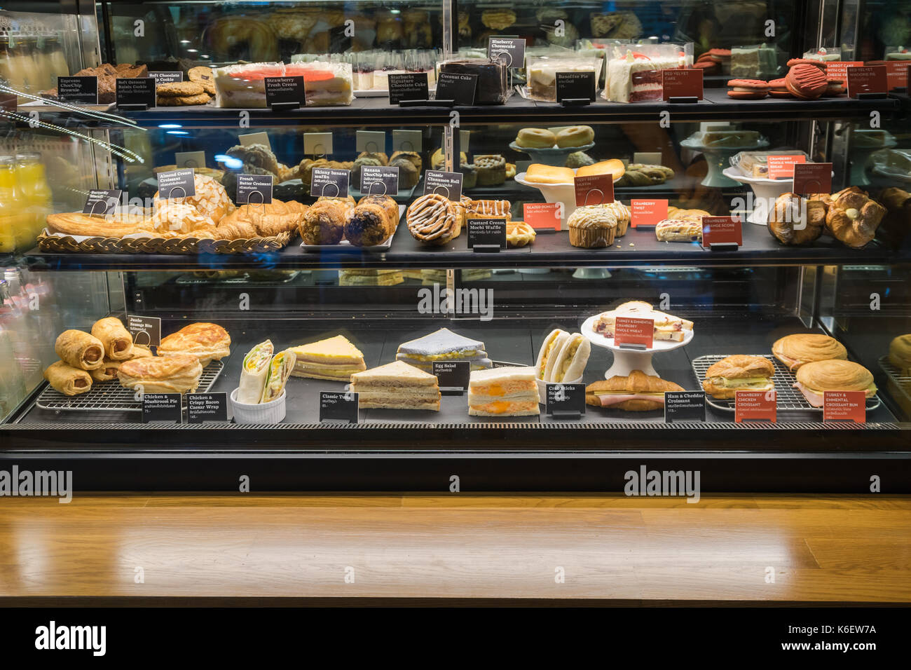 Variety of tasty pastry in glass display Stock Photo Alamy