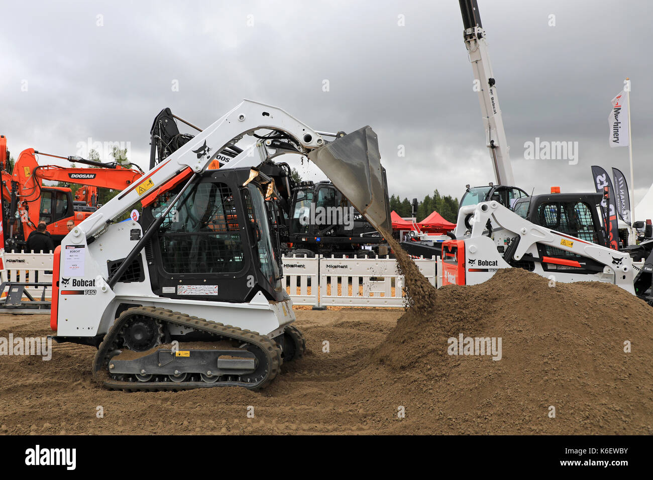 HYVINKAA, FINLAND - SEPTEMBER 8, 2017: Operator works with Bobcat T450 Compact Track Loader on sand work site on Maxpo 2017. Stock Photo