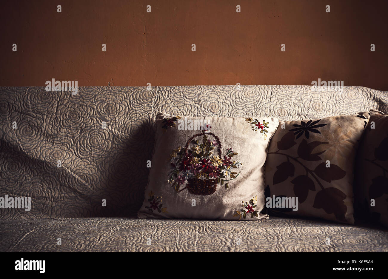 Detail of an old retro styled decorative pillows on couch. Stock Photo
