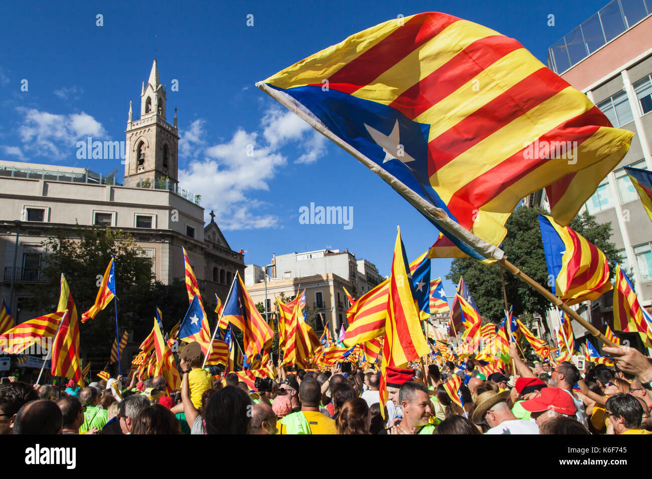 Barcelona, Spain - September 11, 2017: Catalans waving Estelada flags during march for independence on September 11, 2017 in Barcelona, Spain. Stock Photo