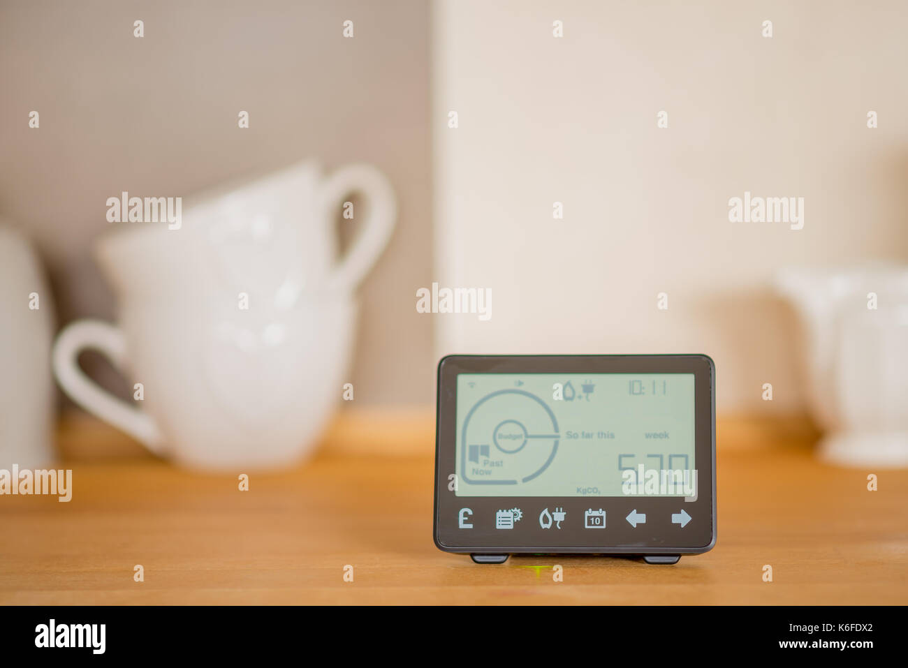 Smart meter on wooden kitchen counter. Stock Photo