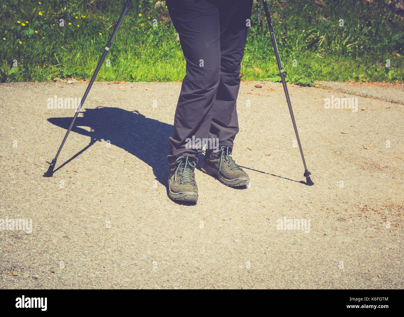 Hiking boots in outdoor action whit sticks in the mountains. Lifestyle Stock Photo