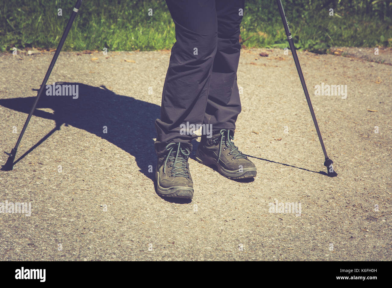 Hiking boots in outdoor action whit sticks in the mountains. Lifestyle Stock Photo