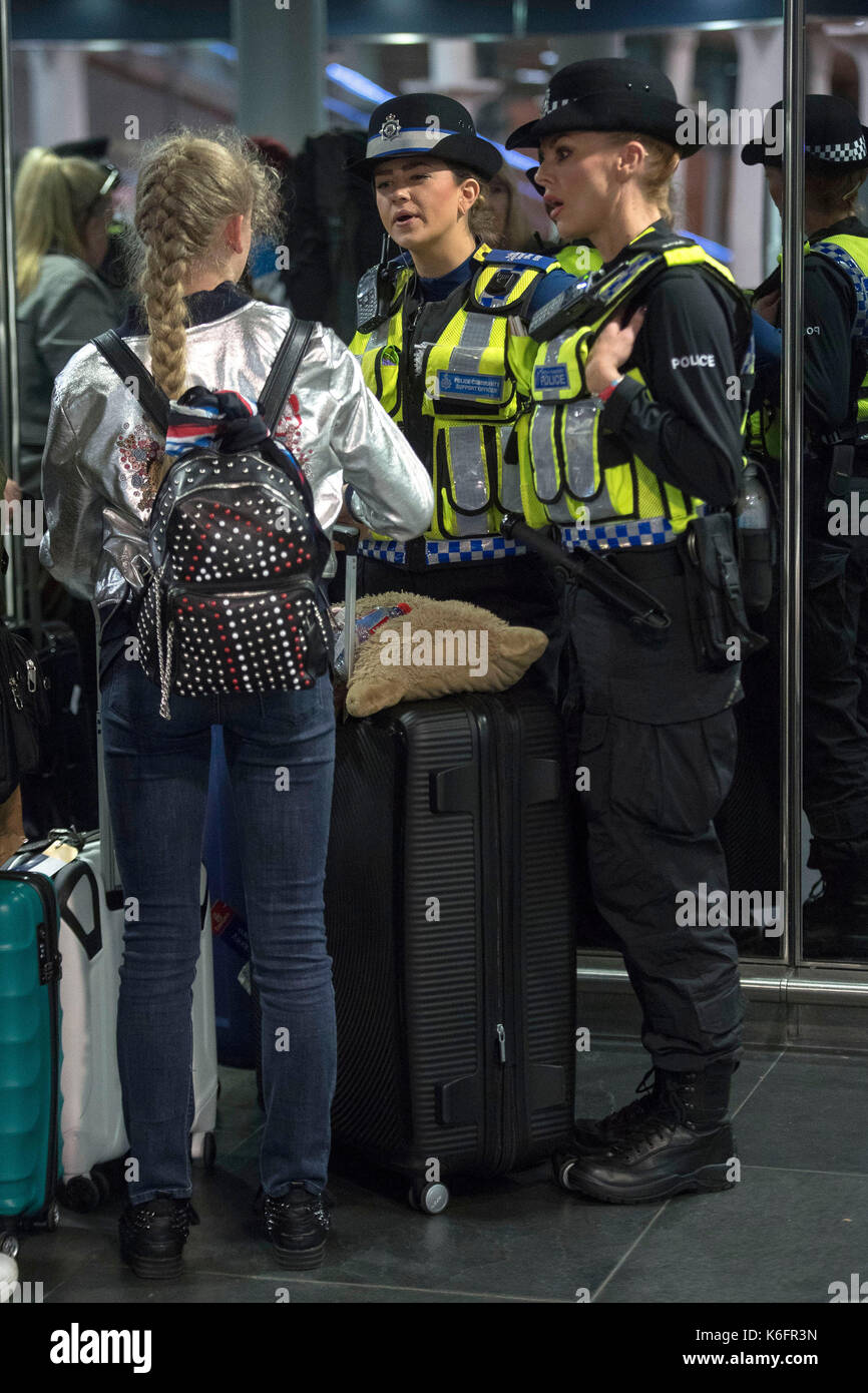Embargoed to 1800 Tuesday September 12 Two officers from British Transport Police talk to a young passenger while taking part in operation Limelight at the Eurostar terminal at St Pancras International in London, which is aimed at safeguarding children and vulnerable people from harmful practices and human trafficking. Stock Photo
