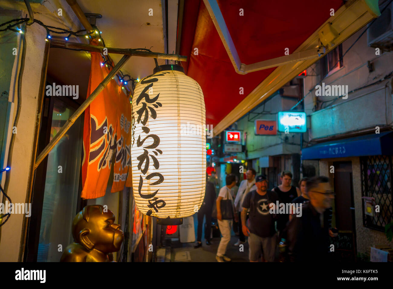 TOKYO, JAPAN JUNE 28 - 2017: White lantern with Japanesse letters at night in traditional back street bars in Shinjuku Golden Gai. Golden gai consists of 6 tiny alleys with 200 tiny bars and 20th century atmosphere, located in Tokyo Stock Photo