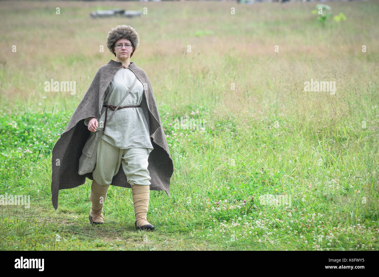 MOSCOW,RUSSIA-June 06,2016: Man in ancient merchant costume stands on green field of grass Stock Photo