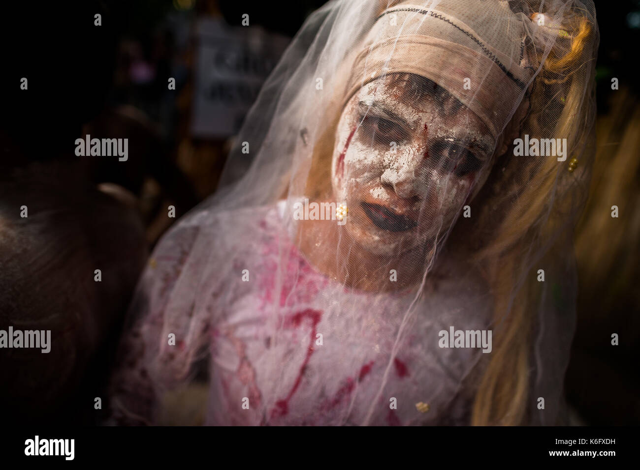 A Salvadoran young man, with white face paint, performs an indigenous mythology character called La Llorona in the La Calabiuza parade at the Day of t Stock Photo