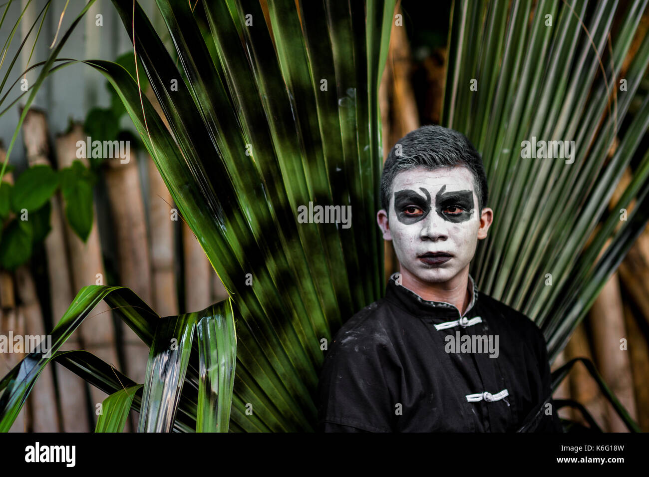 A Salvadoran young man, with white face paint, takes part in the La Calabiuza parade at the Day of the Dead celebration in Tonacatepeque, El Salvador, Stock Photo