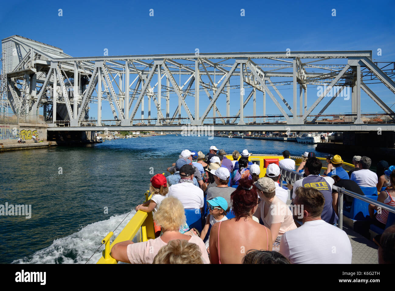 Tourists on Boat Trip Along the Canals of Sète and the Etang or Lake of Thau Hérault Languedoc-Roussillon France Stock Photo