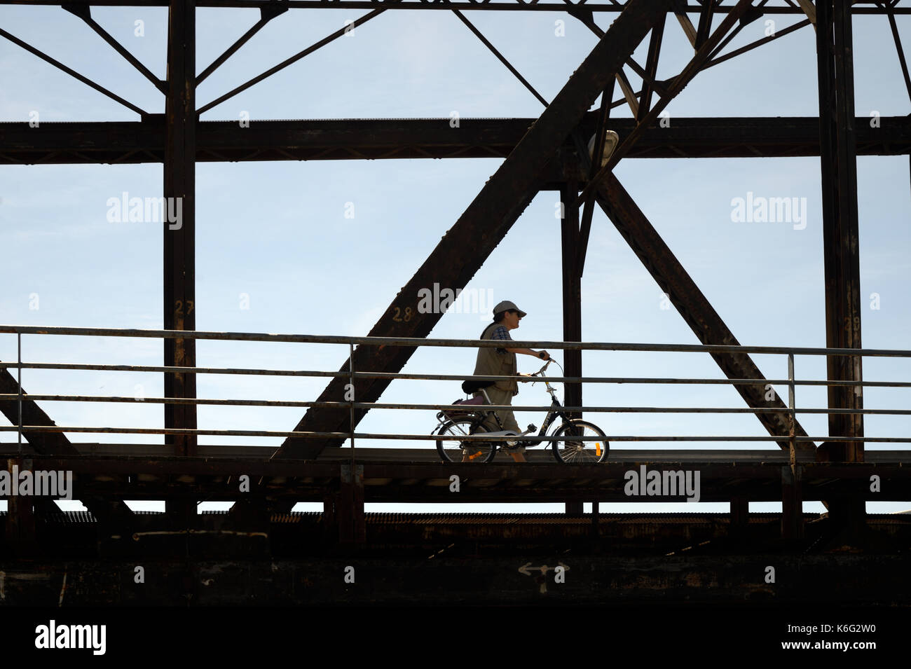 Man & Bicycle Crossing Iron-Framed or Iron Bridge over Canal at Sète or Sete, Hérault, Languedoc-Roussillon, France Stock Photo