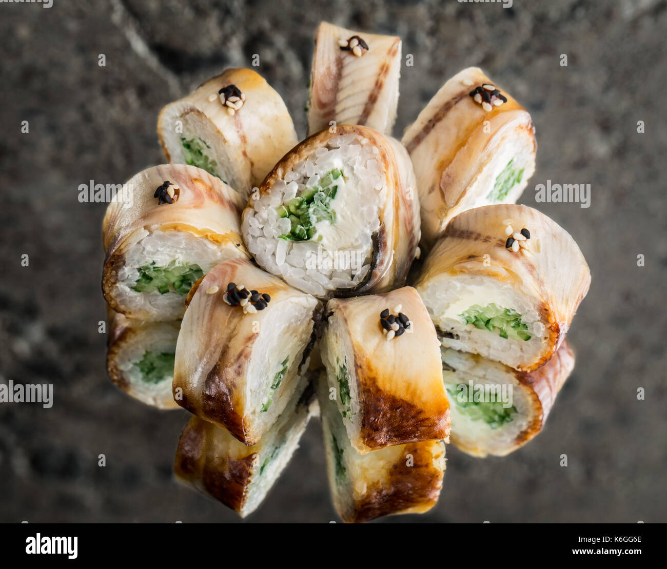 Roll with smoked eel, cream cheese and cucumber Stock Photo