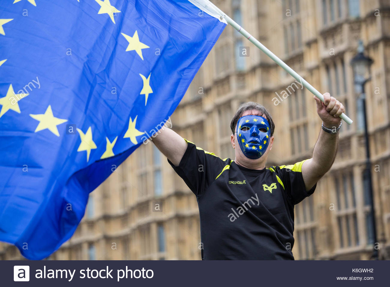 A pro-EU anti-Brexit protester waves EU flags in the air at Westminster during a protest against the first reading of the Withdrawal bill. Stock Photo