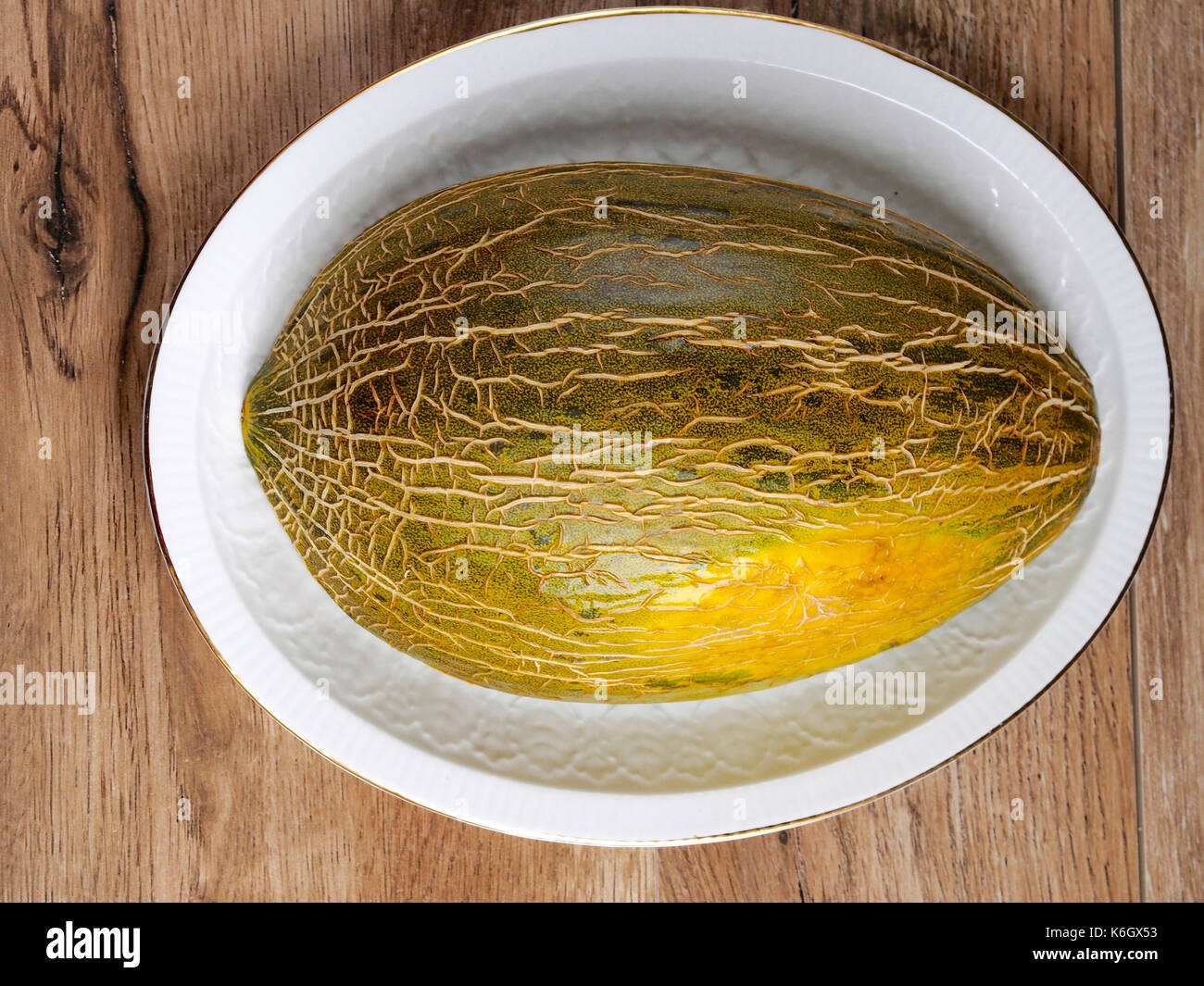Green melon on wood background Stock Photo