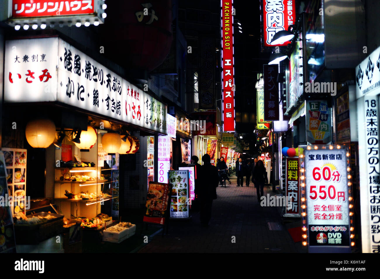 SHINJUKU, TOKYO, JAPAN - DECEMBER 2016 - View of a small street in Shinjuku at night Stock Photo