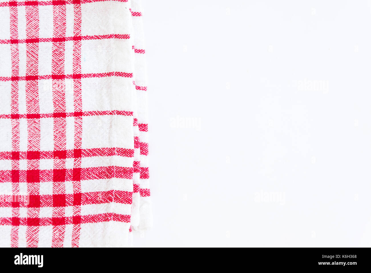 Red cloth, a kitchen towel with a checkered pattern, on a white background isolated. Stock Photo