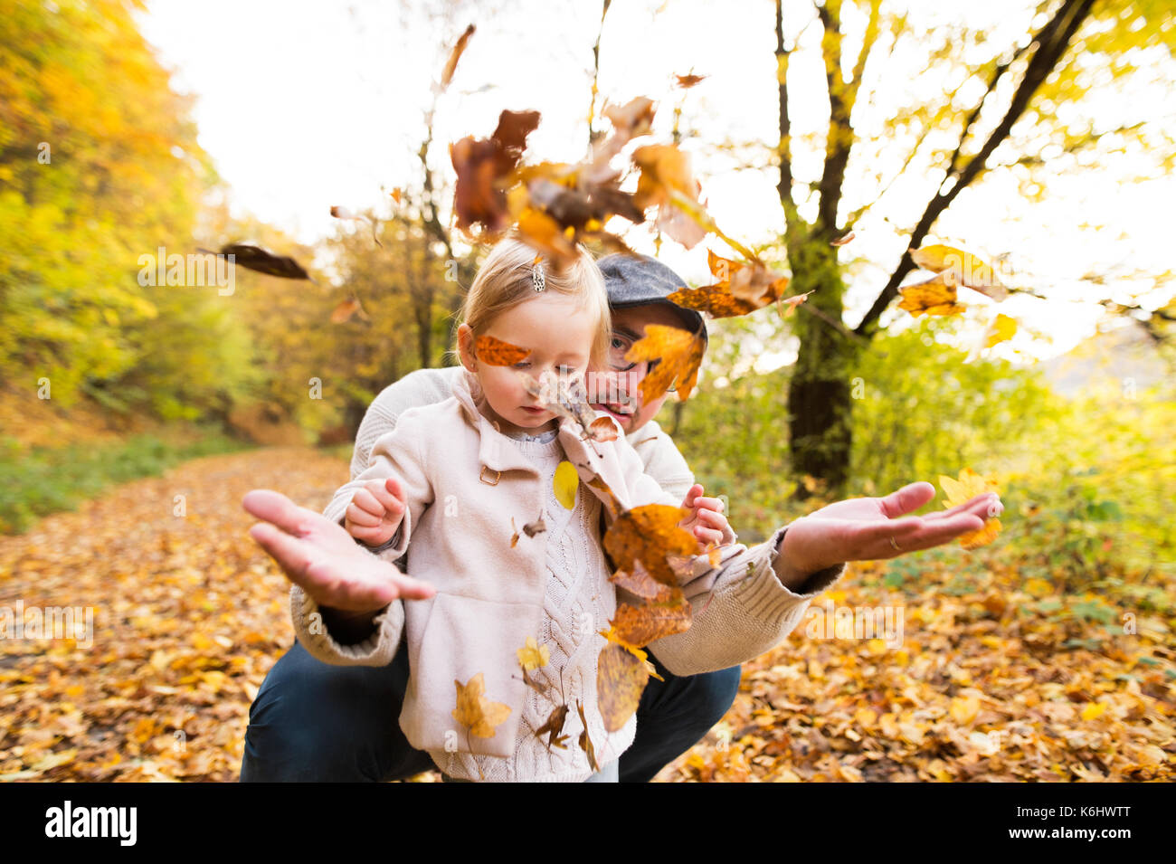 Young father with his daughter in autumn forest Stock Photo - Alamy