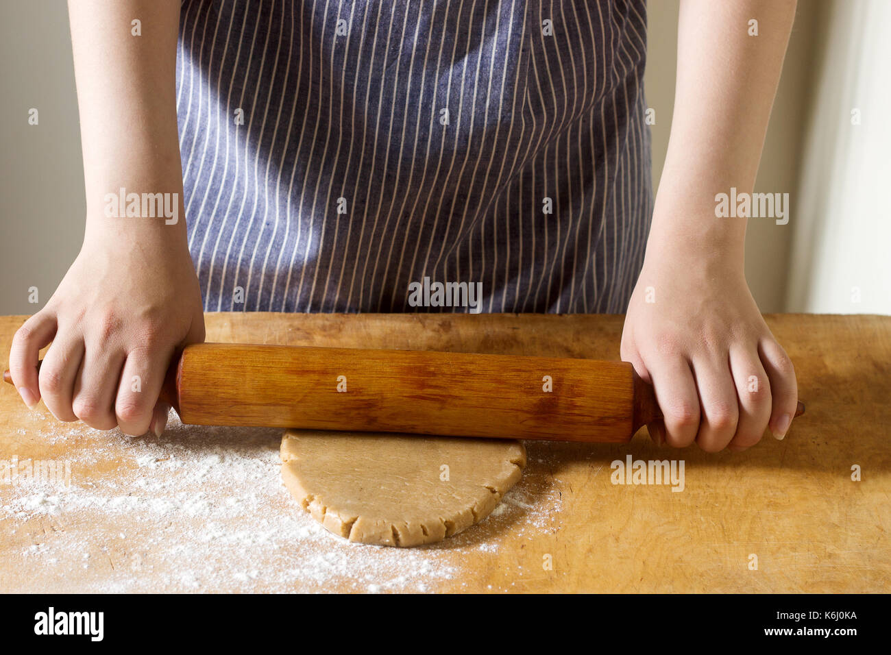 Woman rolling dough for gingerbread, rustic style, selective focus Stock Photo
