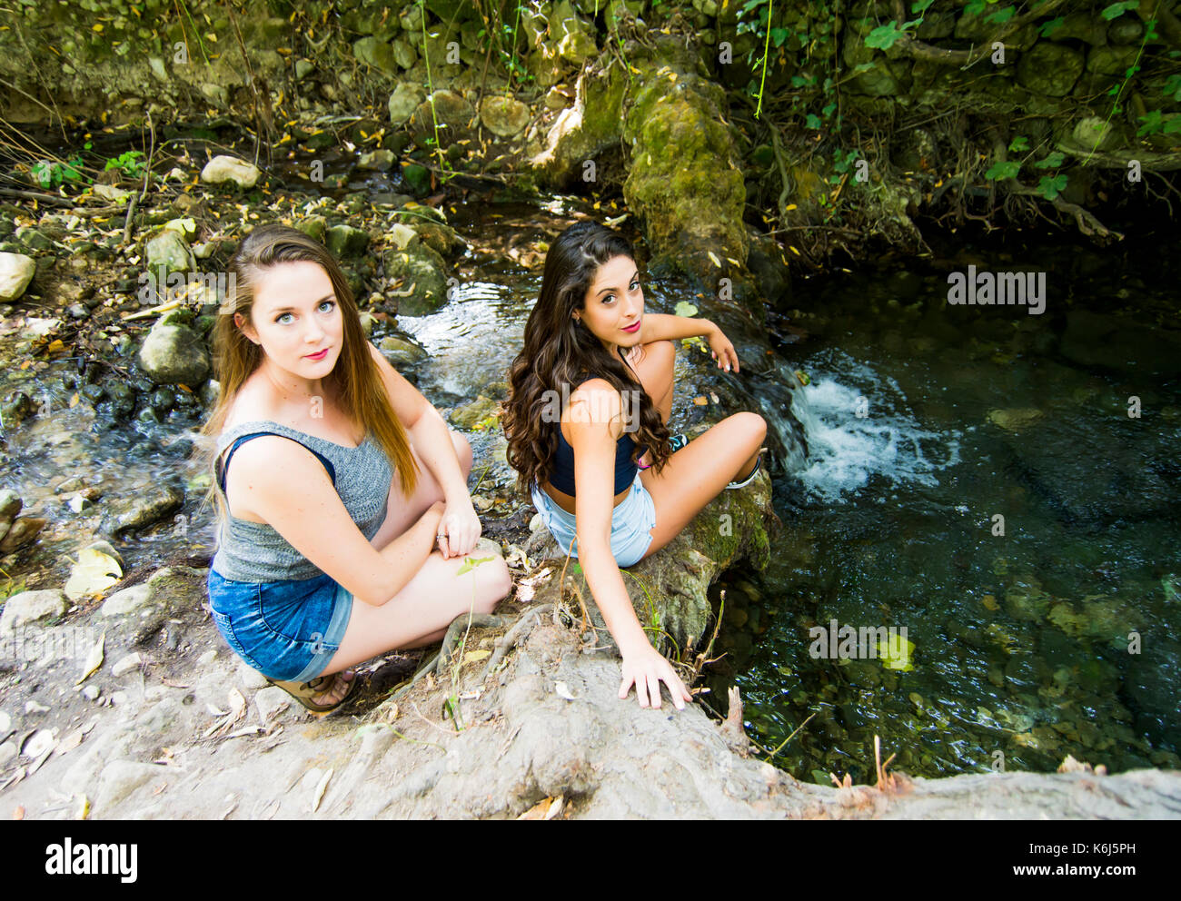 Two beautiful women in nature on the bank of a mountain river Stock ...