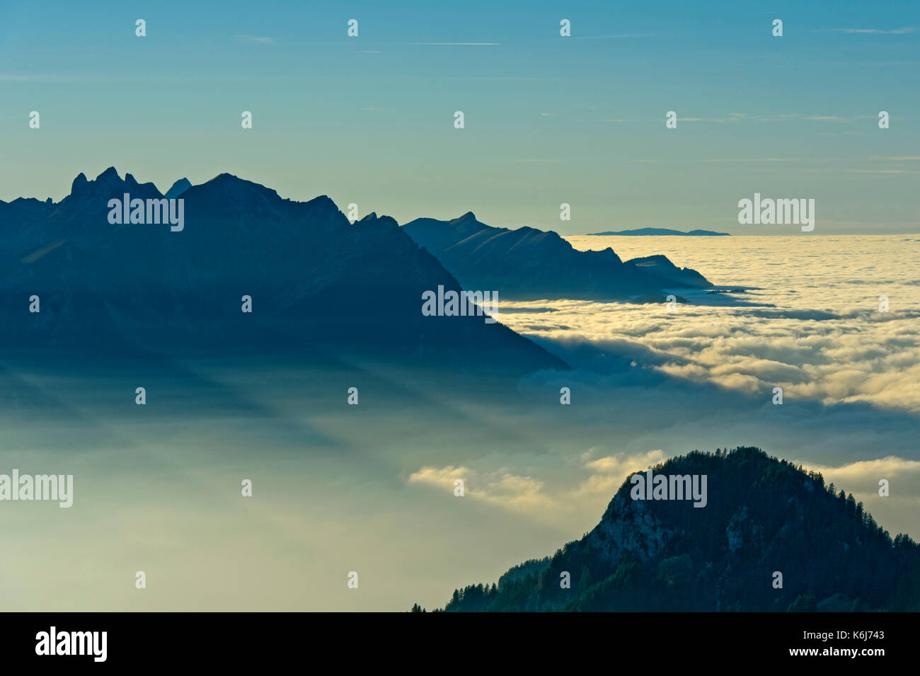 Lake Geneva at sunset under a thick layer of clouds, French Alps to the left, Leysin, Vaud, Switzerland Stock Photo