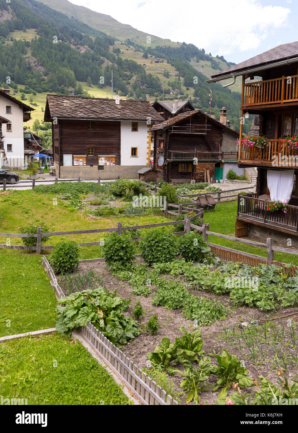 LES HAUDERES, SWITZERLAND - Garden and traditional houses, in the Pennine Alps. Stock Photo