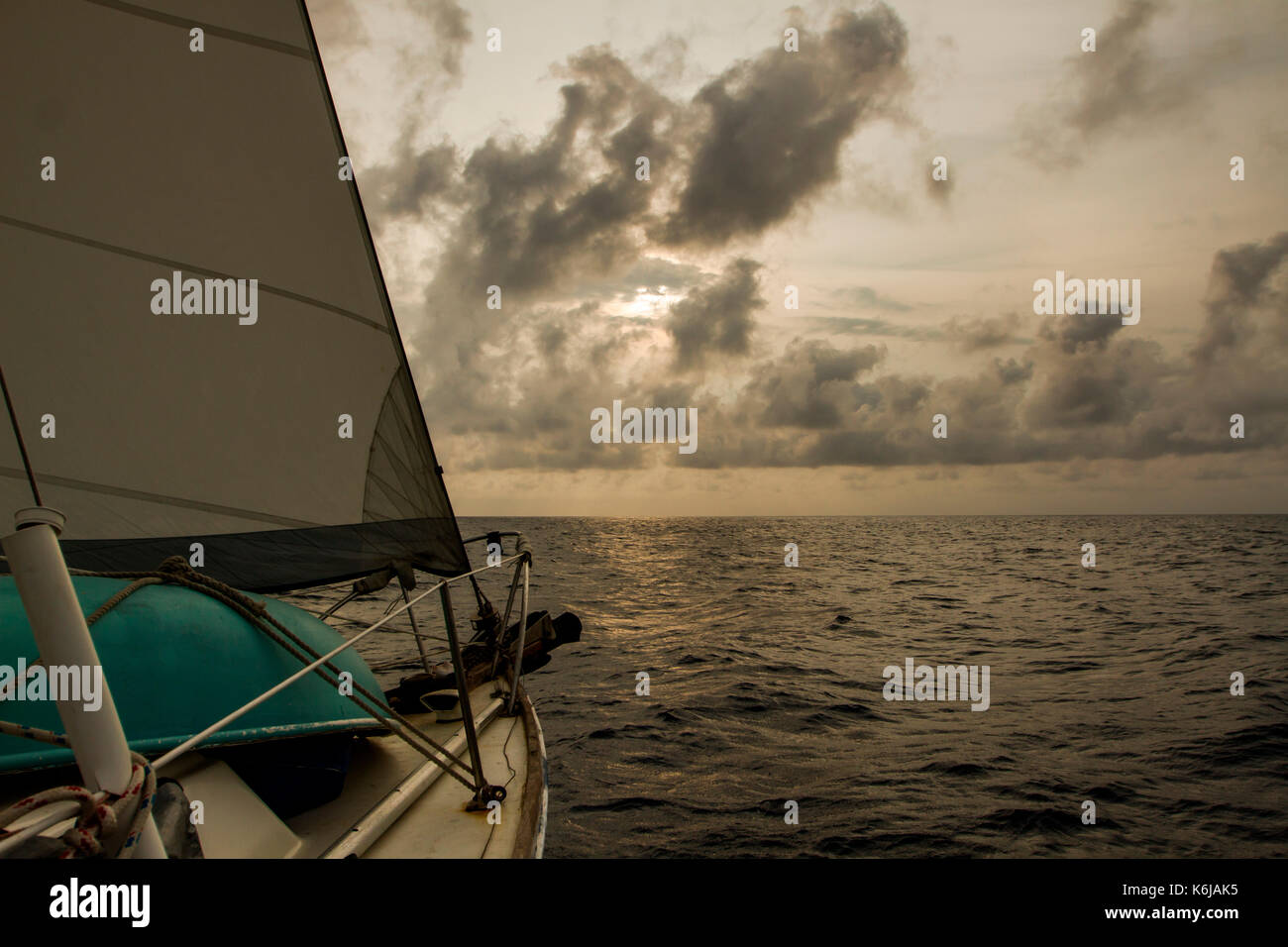 Bow of a sailboat cutting through water on journey over Caribbean Sea, Honduras Stock Photo