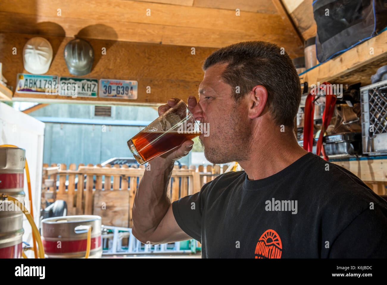 Side view of mature man tasting home brew beer, Bishop, California, USA Stock Photo
