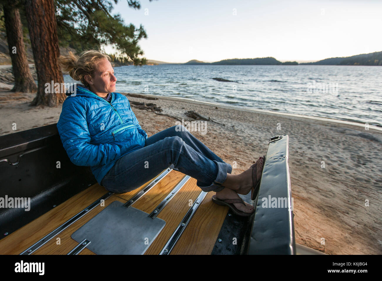 Woman sitting in renovated truck watching sunset, Payette Lake, McCall, Idaho, USA Stock Photo
