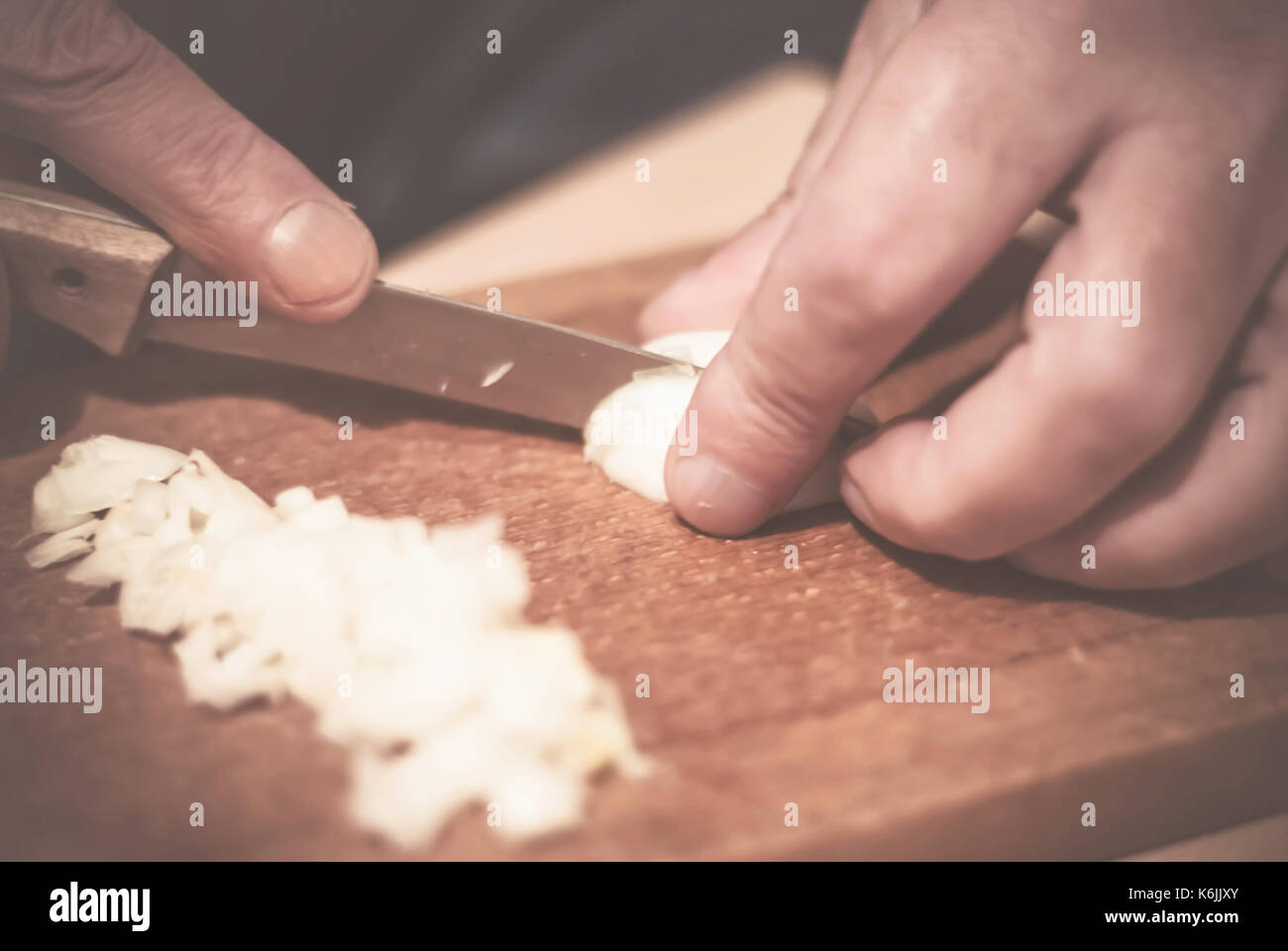 Man cut onions on a board, closeup Stock Photo