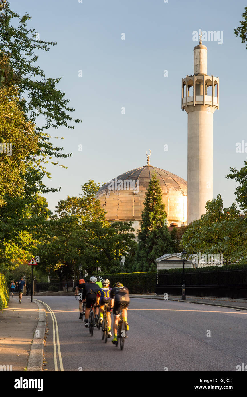 London, England, UK - August 30, 2016: Cyclists pass the London Central Mosque on Regents Park's Outer Circle Road. Stock Photo