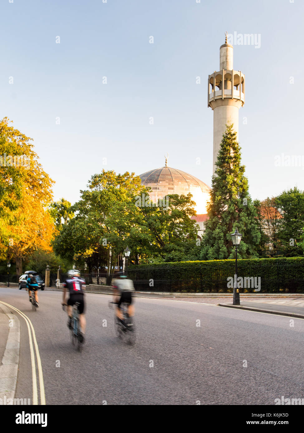 London, England, UK - August 30, 2016: Cyclists pass the London Central Mosque on Regents Park's Outer Circle Road. Stock Photo
