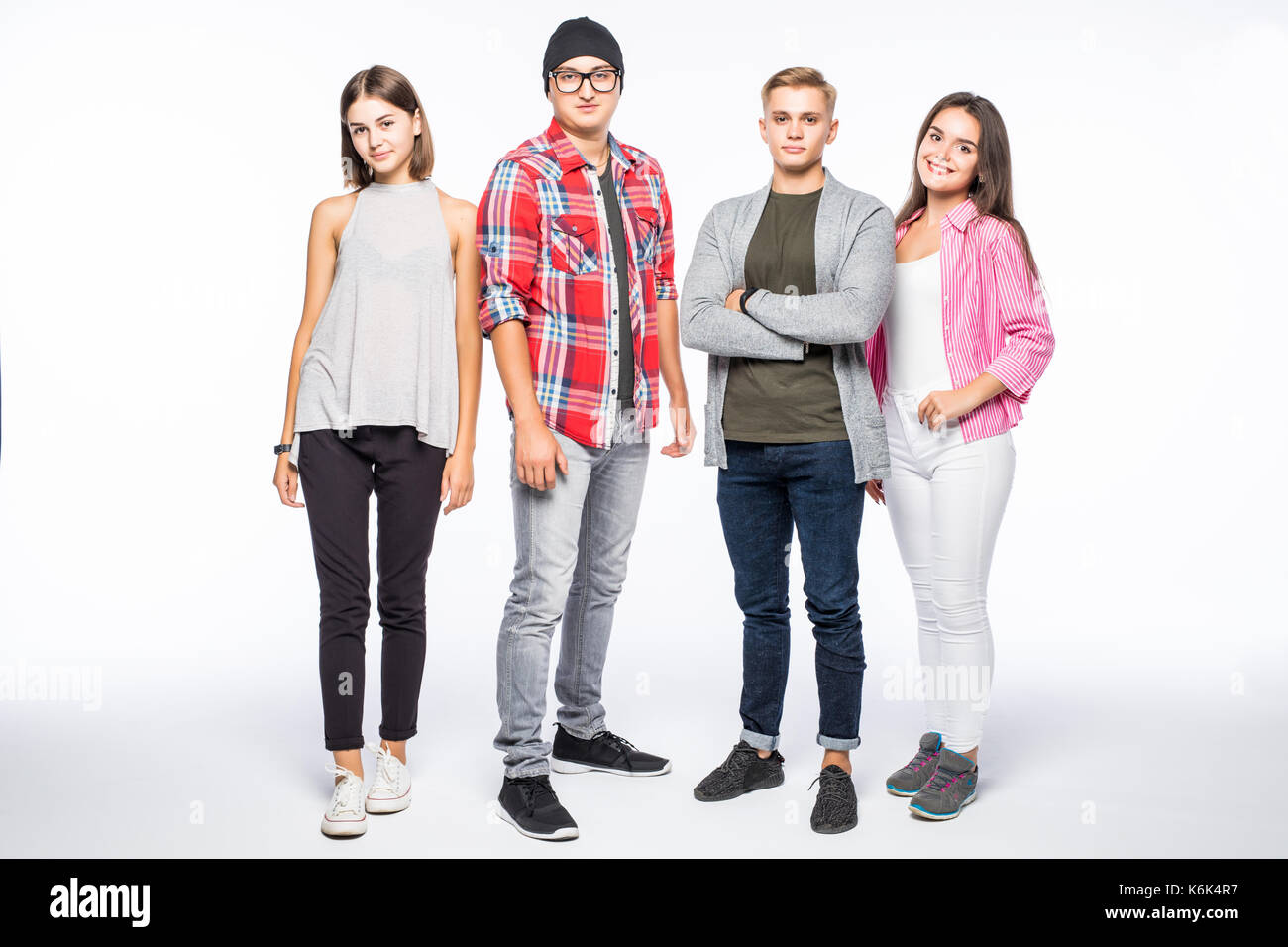 Full length of causal young four friends posing in front of camera Stock Photo