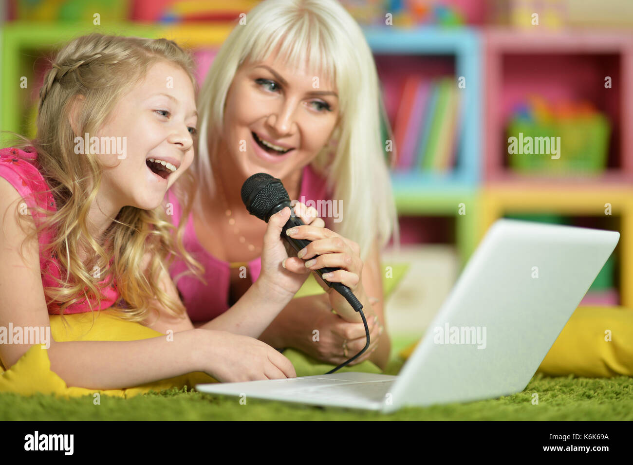 mother and daughter singing karaoke Stock Photo Alamy