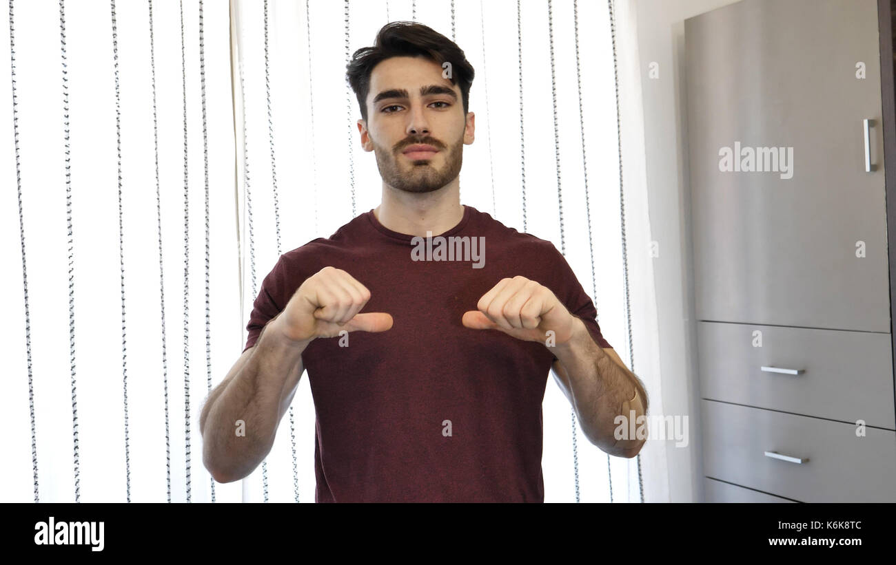 Handsome young man pointing finger at himself, smiling Stock Photo