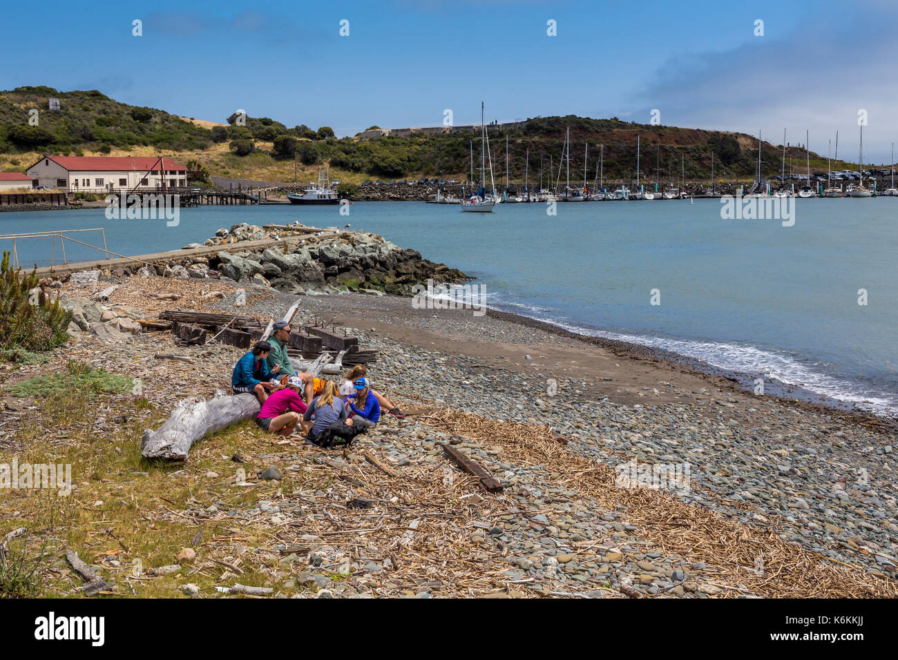 people, family, tourists, visitors, sitting on beach, beach, Fort Baker, city of Sausalito, Sausalito, Marin County, California, United States, North  Stock Photo