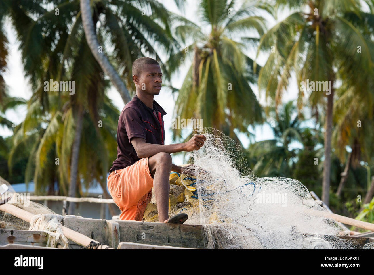 Fisherman fixing a net, Nosy Be, Madagascar Stock Photo