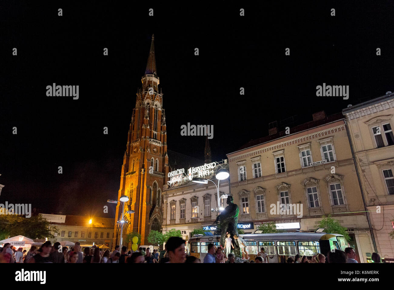 OSIJEK, CROATIA - AUGUST 25, 2017: Crowd gathering at a food festival on the main square of Osijek, Ante Starcevic square. The Cathedral of the city c Stock Photo