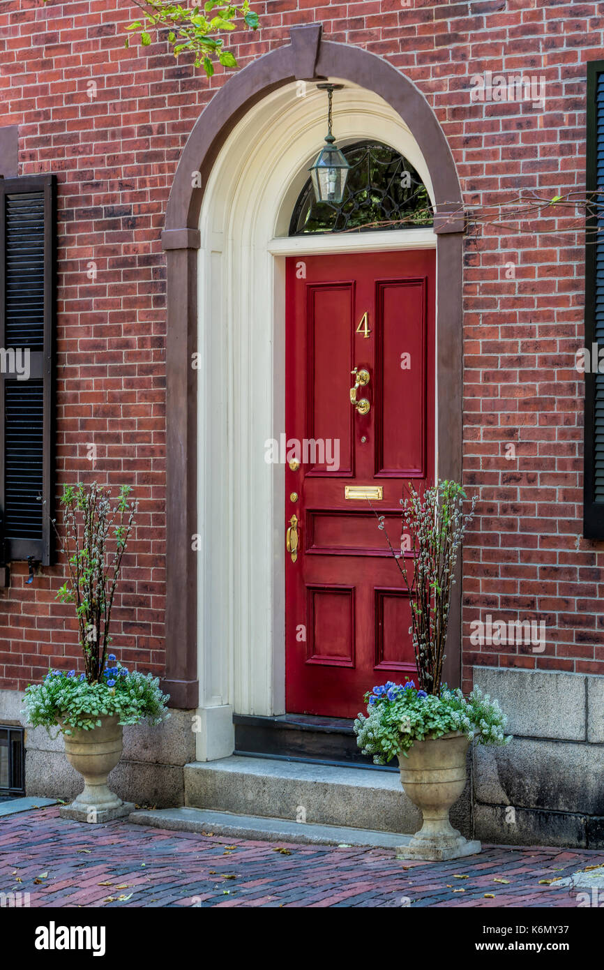 Beacon Hill Red Door - Details found by Acorn Street in Boston. One of the last true cobblestone streets left in Boston, Massachusetts, is located in the famous Acorn Street at Beacon Hill. It is in a neighborhood of Federal-style row-houses and is known for its narrow, gaslit streets and brick sidewalks as well. Acorn Street, is often mentioned as the 'most frequently photographed street in the United States.   Available in color as well as in a black and white print.   To view additional images from Boston please visit: www.susancandelario.com Stock Photo