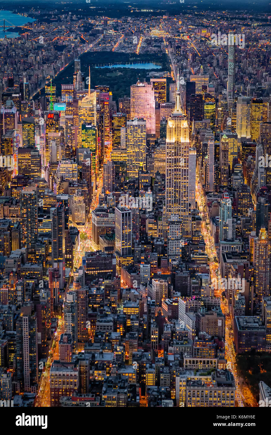 High On New York City - Aerial view over midtown Manhattan in NYC with a view to the Empire State Building ESB, Central Park along with other skyscrapers in the Manhattan, New York City skyline. Stock Photo