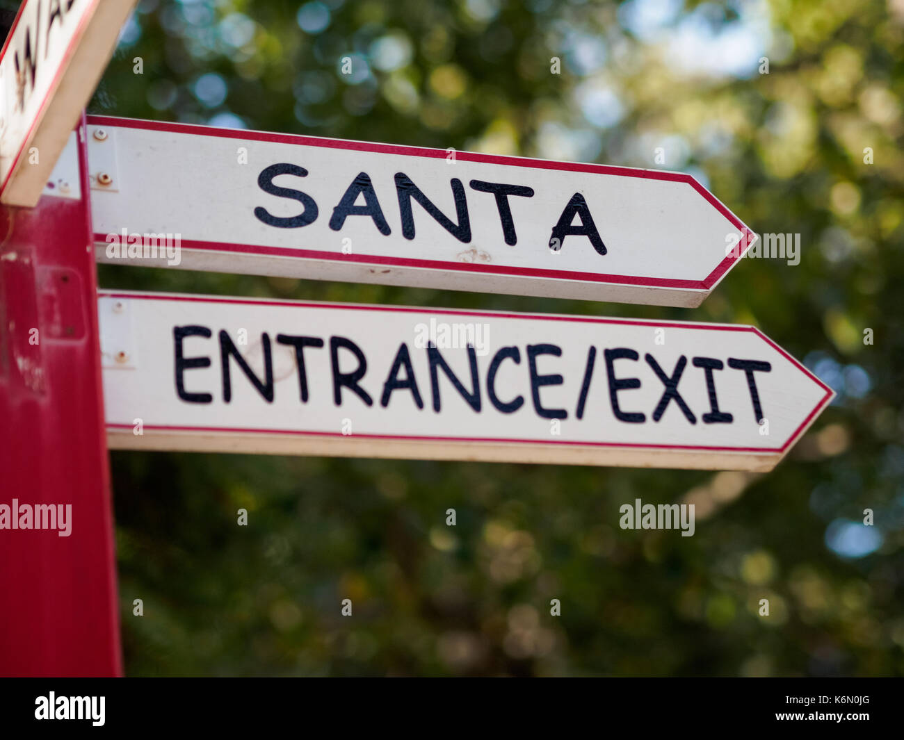 A signpost showing directions to meet Santa Claus depicting where Santa lives Stock Photo
