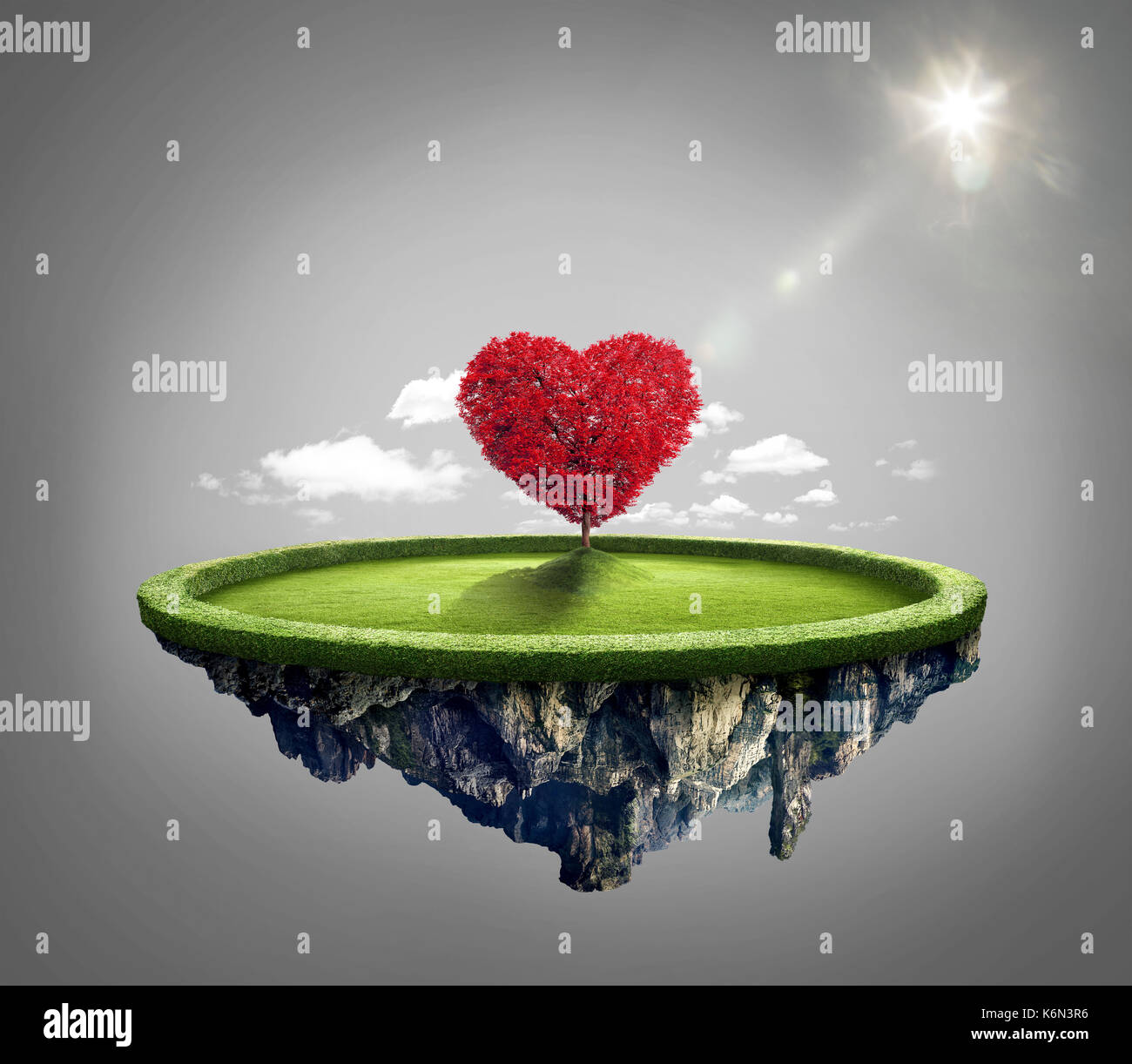 Amazing island with red love heart tree floating in the air under lovely sun ray Stock Photo