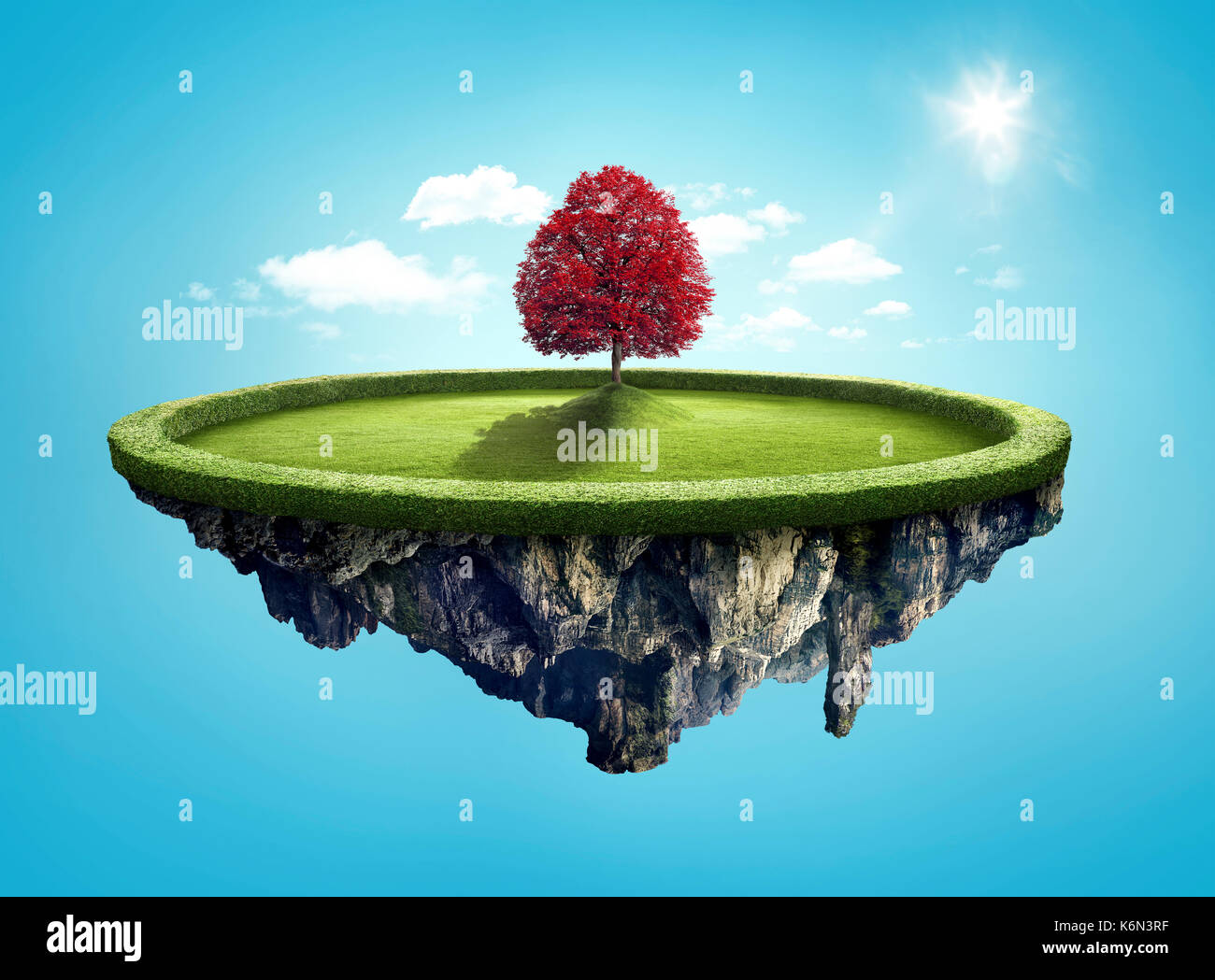 Amazing island with red tree floating in the air under clouds and lovely sun ray Stock Photo