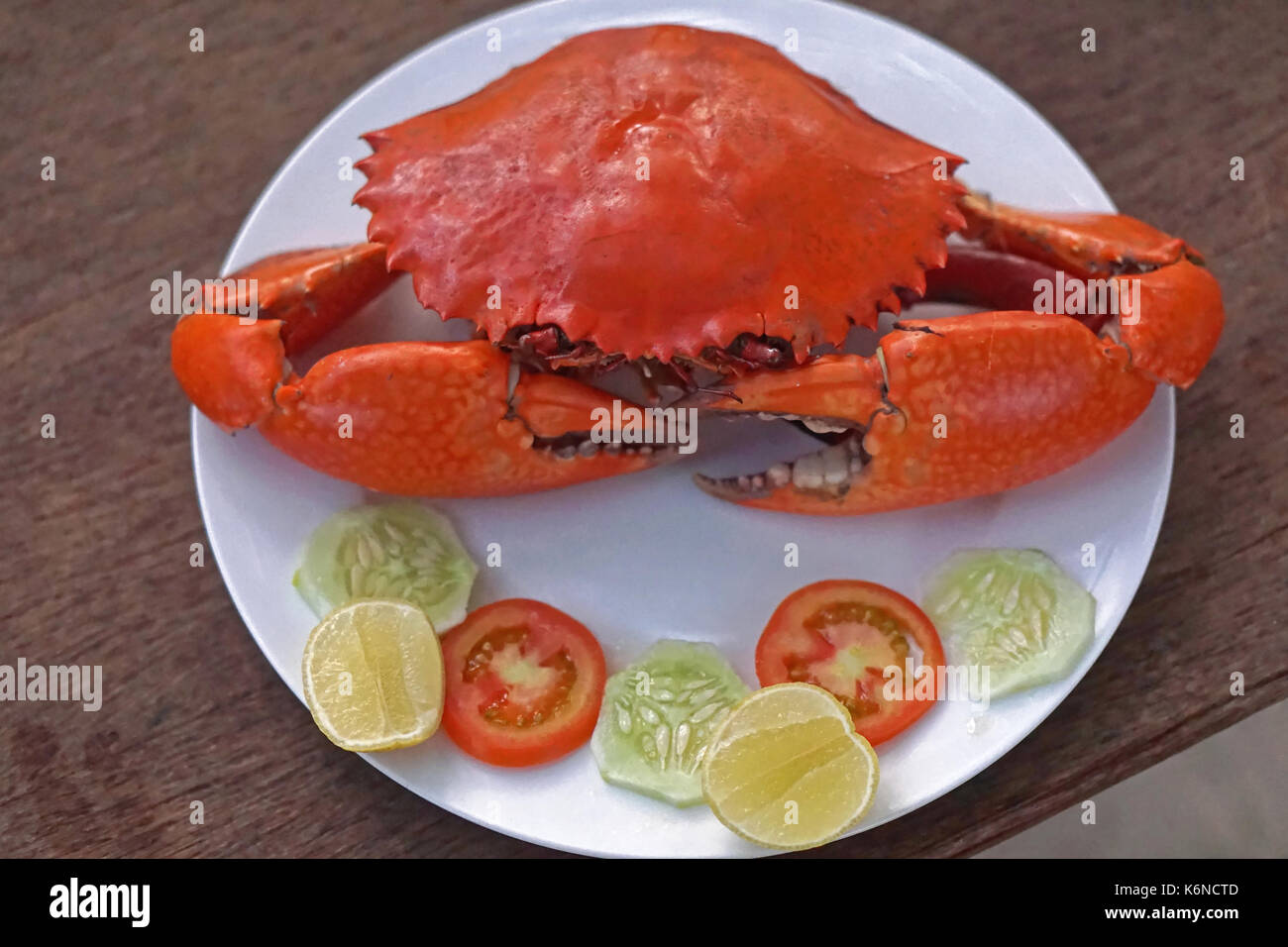 Orange cooked crab served at plate Stock Photo Alamy