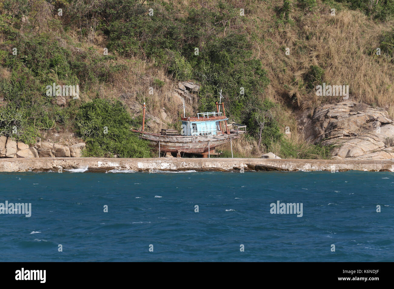 Deserted island in the sea and fishing boat of Tropical Area chonburi province in thailand. Stock Photo