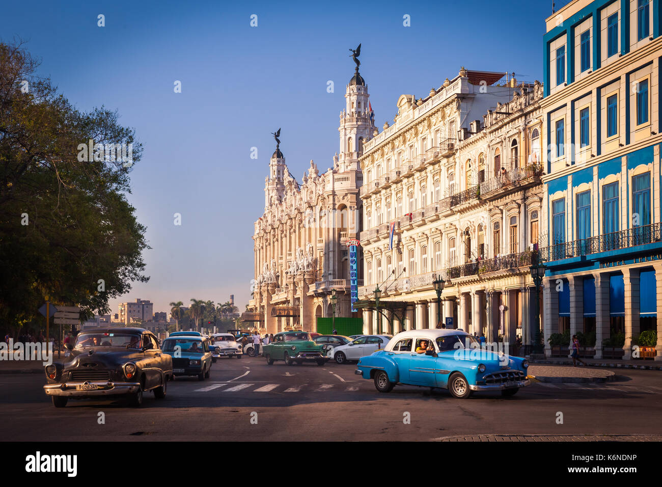 Central Square (Parque Central) with Inglaterra Hotel and The Great Theater of Havana on the left, Havana, Cuba. 1950s cars drive through the street. Stock Photo