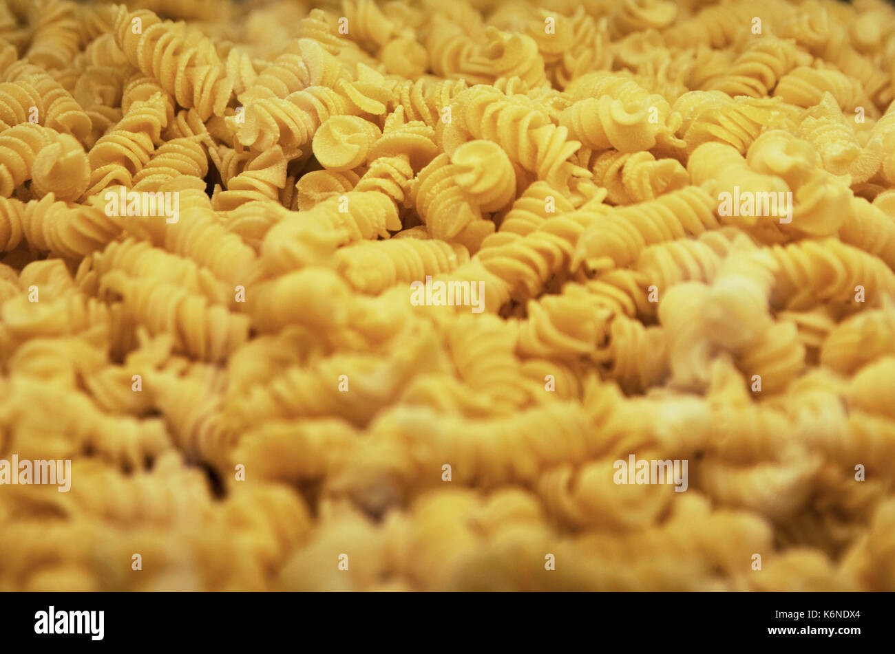 Italian Fusilli or Rotini helix shaped Macaroni Pasta food background